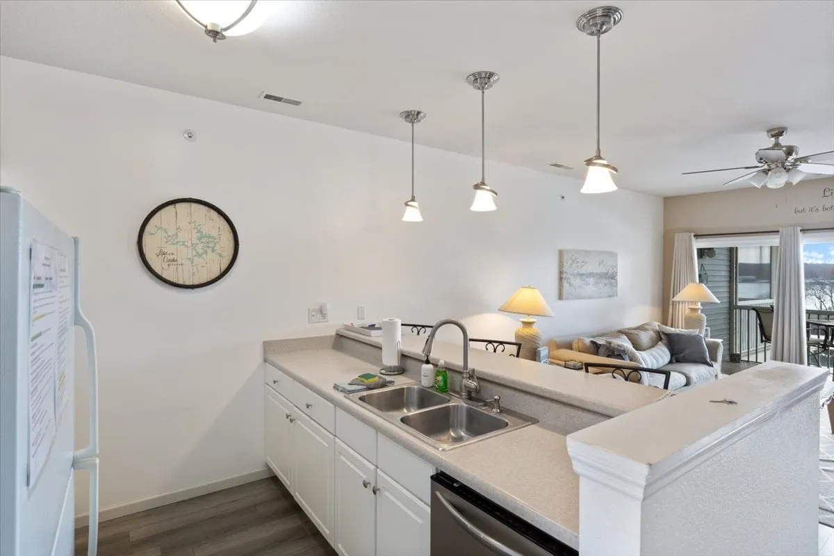 A close-up of the kitchen area featuring a stylish countertop with a sink, pendant lighting, and a cozy seating nook. The kitchen looks fully stocked and ready for everything from breakfast to entertaining guests.